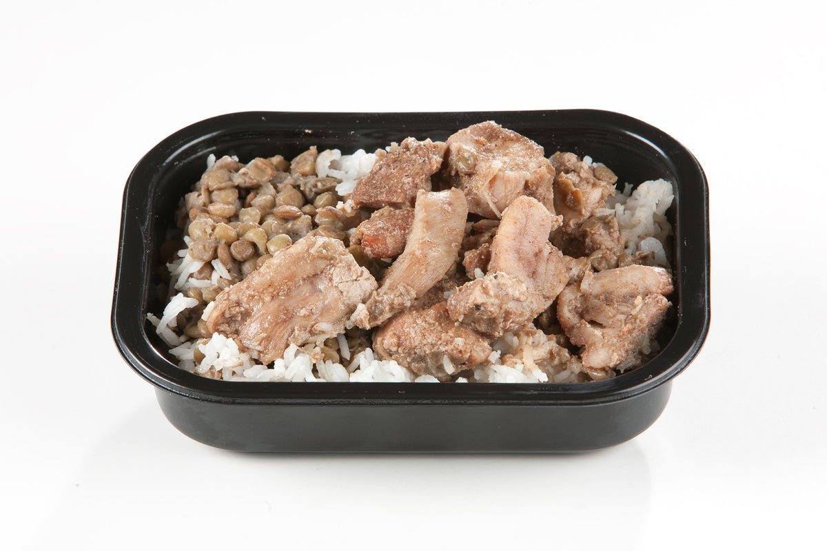 A packaged meal containing Halal chicken thigh pieces, onions, and rice served in a black tray.