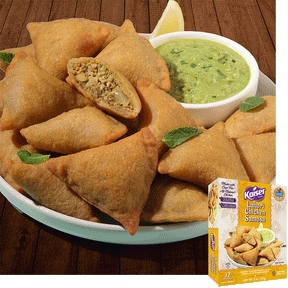 Kaiser Lahori Chicken Samosas in a pile on a white plate with some mint leaves. A bowl of chutney sits next to the pile. One samosa is cut in half and a minced meat mixture is visible inside. A package of Kaiser Lahori Chicken Samosa is overlaid in the bottom right corner.