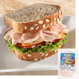 a turkey sandwich with oats baked into the top of the bread. The sandwich is piled high with Midamar halal turkey which is resting on a slice of cheese, tomatoes, and lettuce. In the bottom corner is an image of the product package