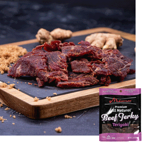 Midamar Halal Beef jerky Teriyaki pieces sit in a pile on a cutting board, brown sugar is sprinkled around and ginger is visible in the background. Overlaid is a picture of the bag.