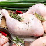 Raw chicken with herbs and spices on a wooden cutting board