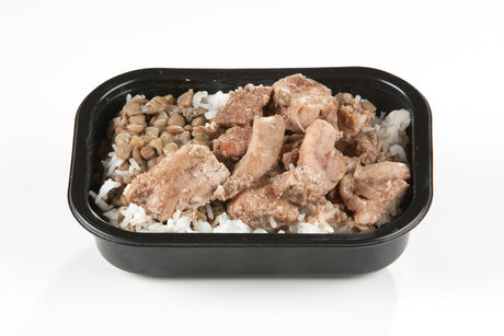 A packaged meal containing Halal chicken thigh pieces, onions, and rice served in a black tray.